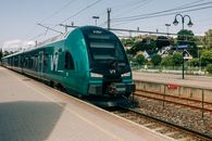 A modern passenger train at Sandefjord station in Norway. Urban transportation captured on a sunny day.