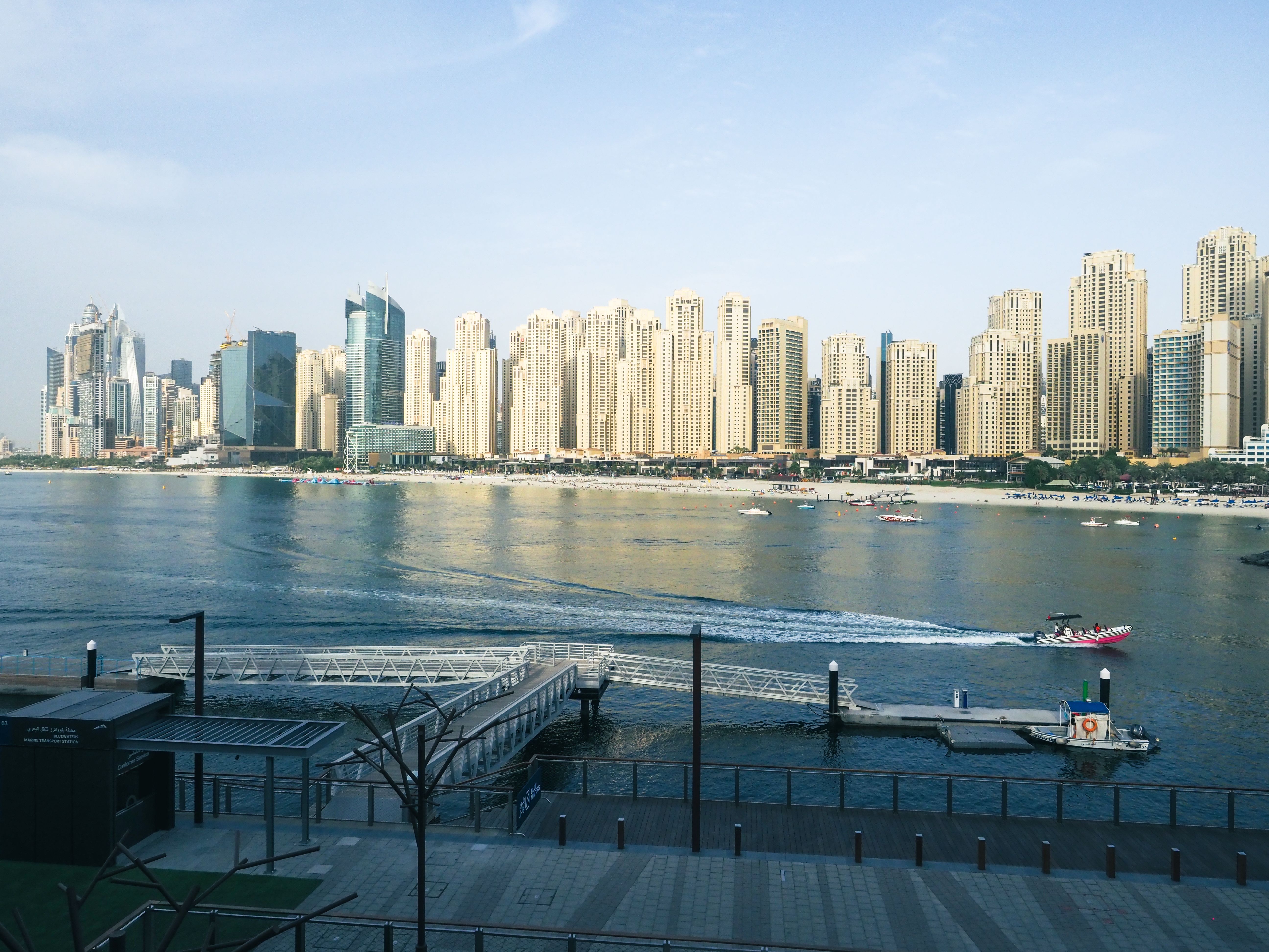 Monochrome view of Dubai's skyline from the sea, featuring skyscrapers and coastline.