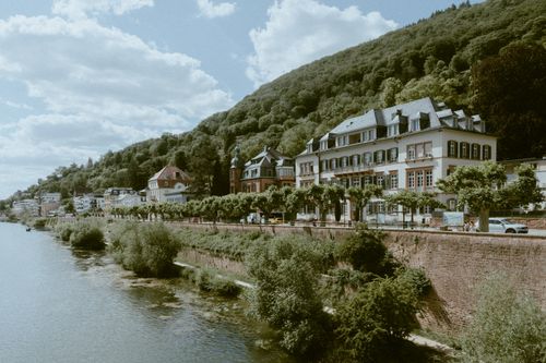 Free Charming hillside town in Europe with historic architecture along a peaceful river. Stock Photo