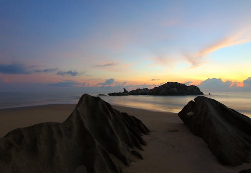 Island on Sea Under Blue Sky at Golden Hour