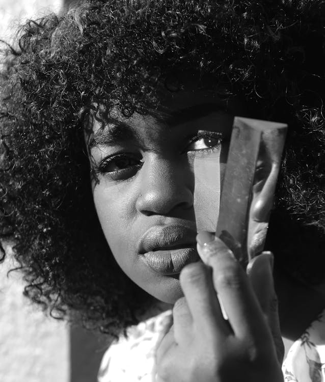 Grayscale Photography of Woman Holding a Broken Mirror