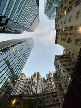 Dramatic view of skyscrapers towering into a clear sky in a bustling downtown.