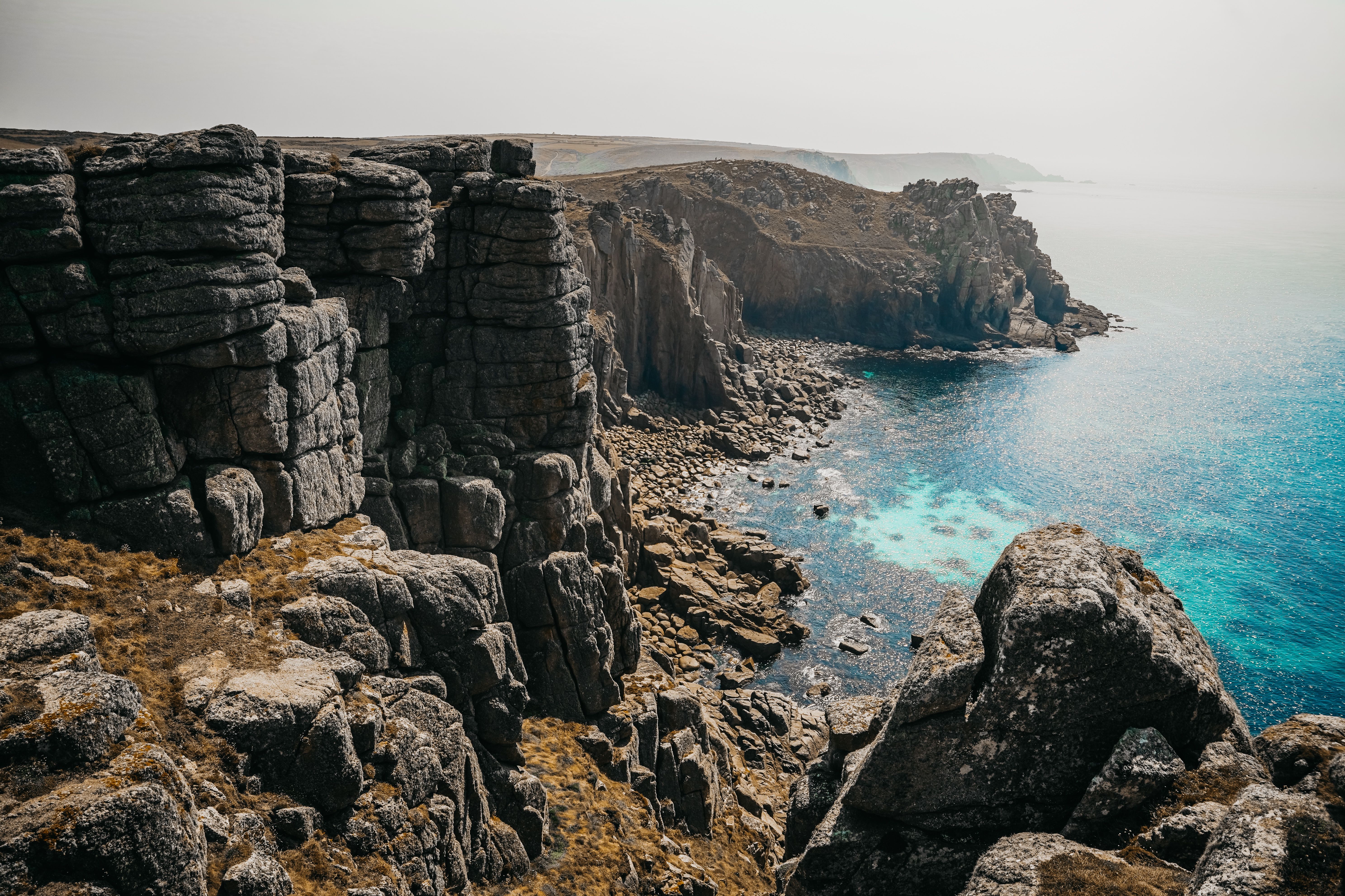 Stunning view of the rugged coastal cliffs in St Ives, England with turquoise waters below.
