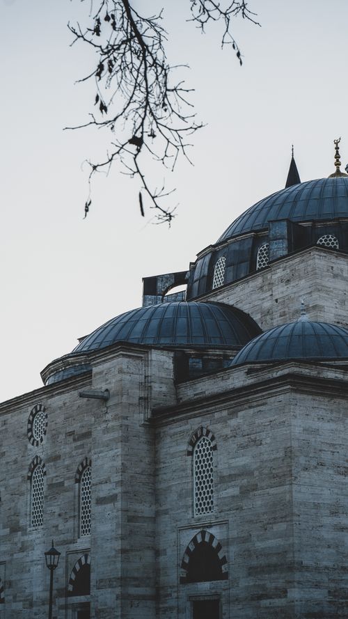 Free A dramatic view of Suleymaniye Mosque's domes against a twilight sky in Istanbul, Turkey. Stock Photo