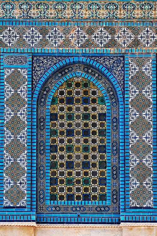 Free Vertical shot of ornate mosaic patterns on a mosque wall, showcasing vibrant blues and intricate designs. Stock Photo
