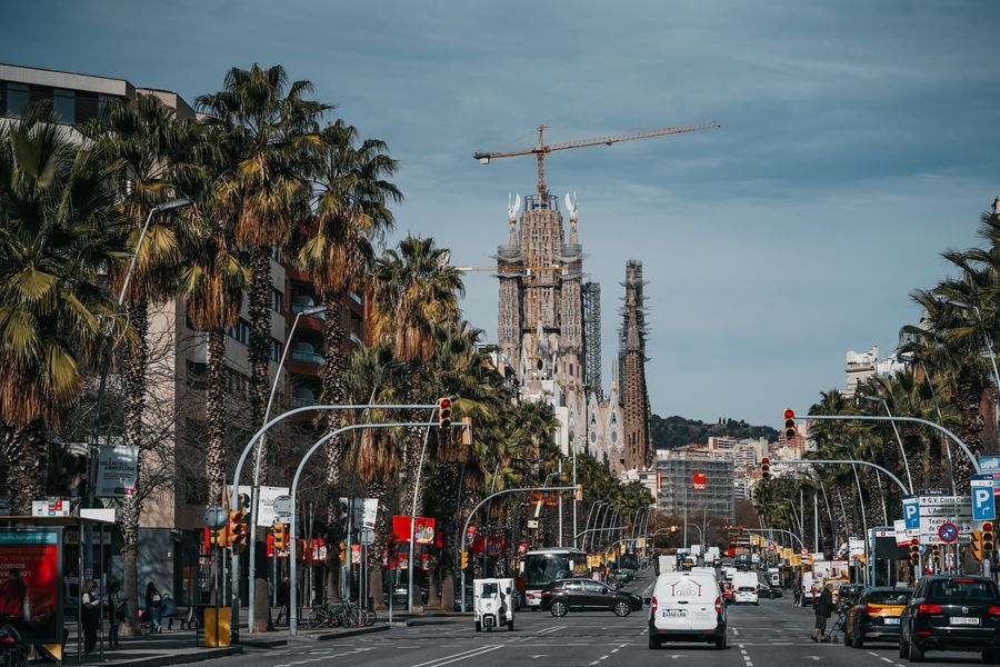 Una calle de Barcelona con la Sagrada Família asomando al fondo