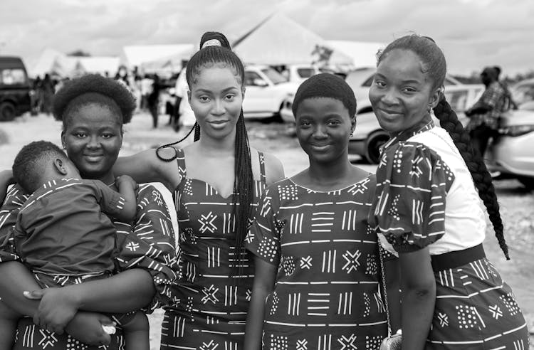 A Group Of Women Standing Outdoors