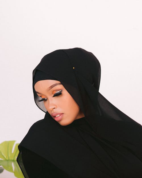Young Woman Wearing a Black Dress and Headscarf 