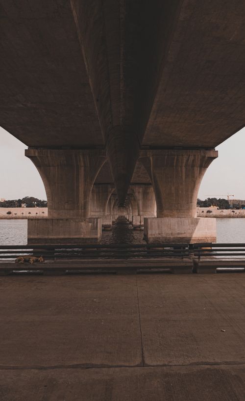 Free Symmetrical perspective of a concrete bridge over a river in Ahmedabad, India. Stock Photo
