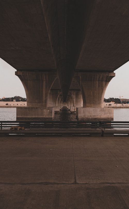Free A moody view of an architectural bridge structure spanning a river in Ahmedabad, India. Stock Photo