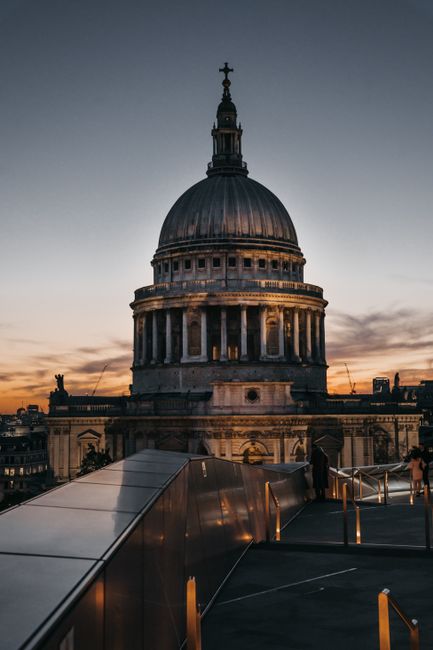 Discover the beauty of St. Paul's Cathedral in London illuminated against a vibrant sunset.