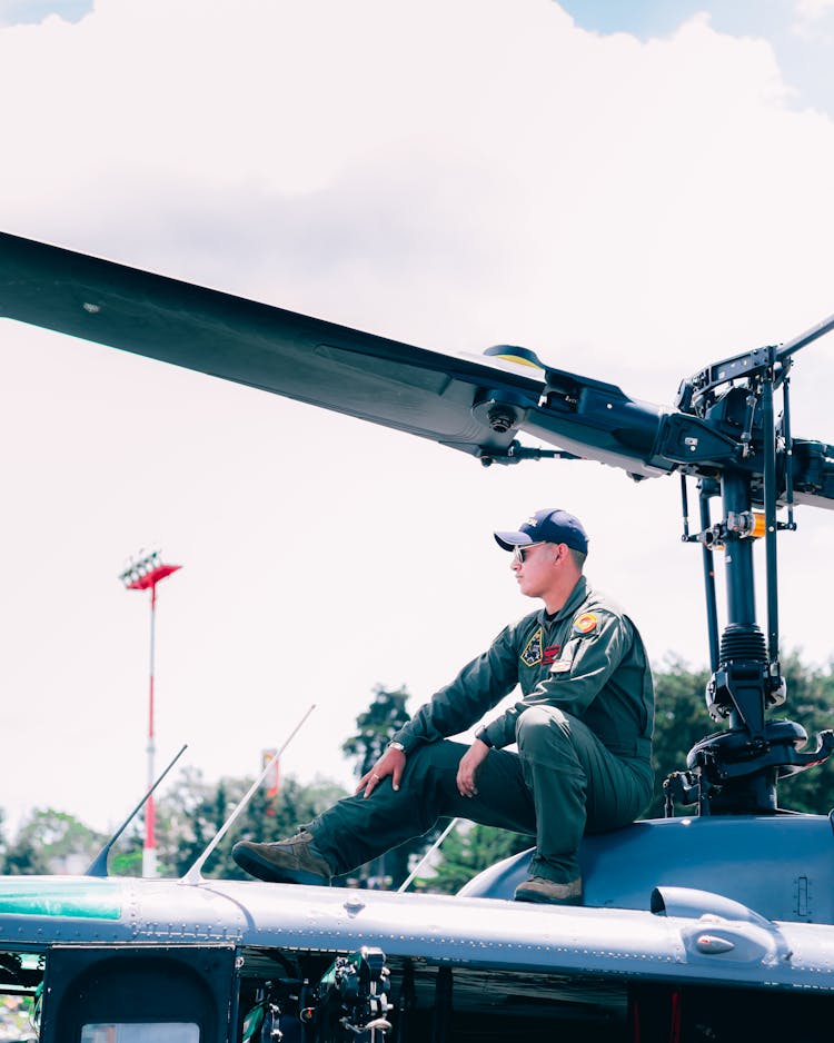 Soldier Sitting On Helicopter