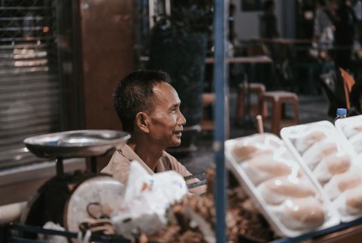 Night market textiles with a weaver — Luang Prabang