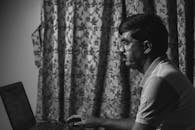 Man Sitting and Working on Laptop