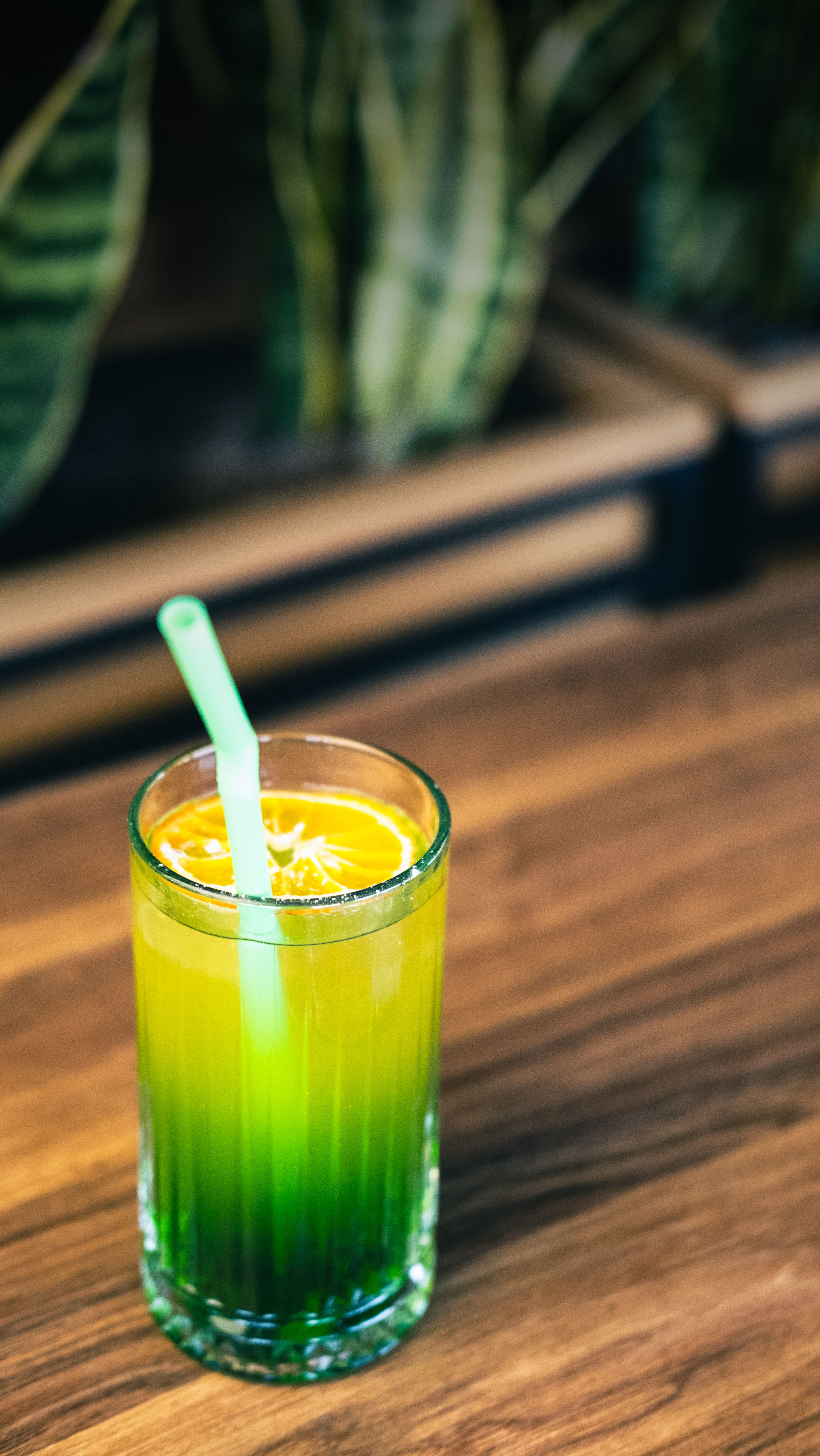 Colorful cocktail with straw on a wooden table in Antalya.