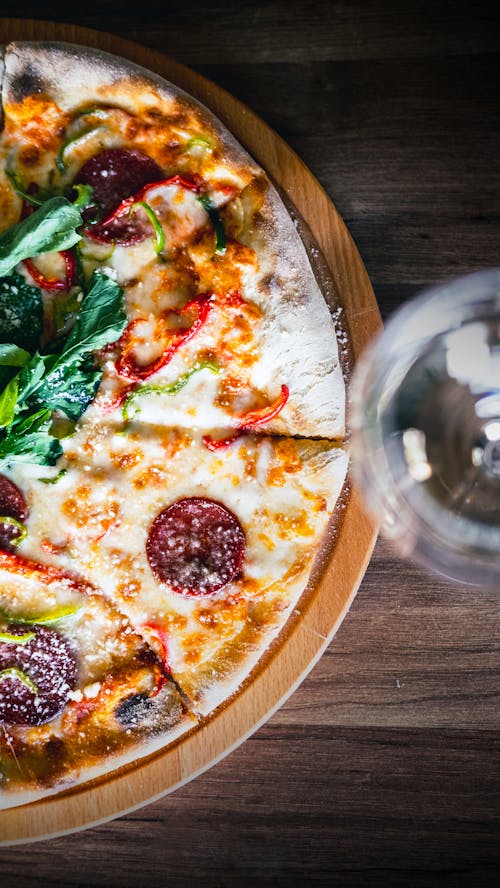 Top View of a Pizza and a Glass with a Drink 