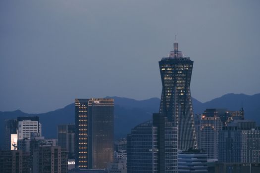Stunning cityscape with glowing skyscrapers against a twilight sky.