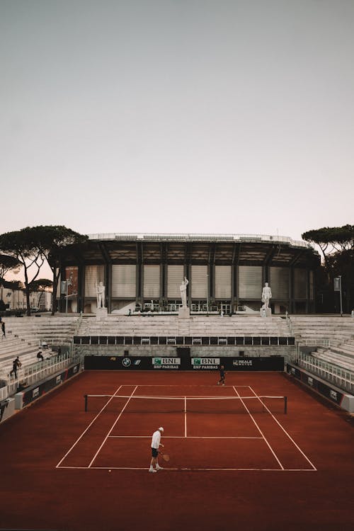 Men Playing Tennis on Court in Rome