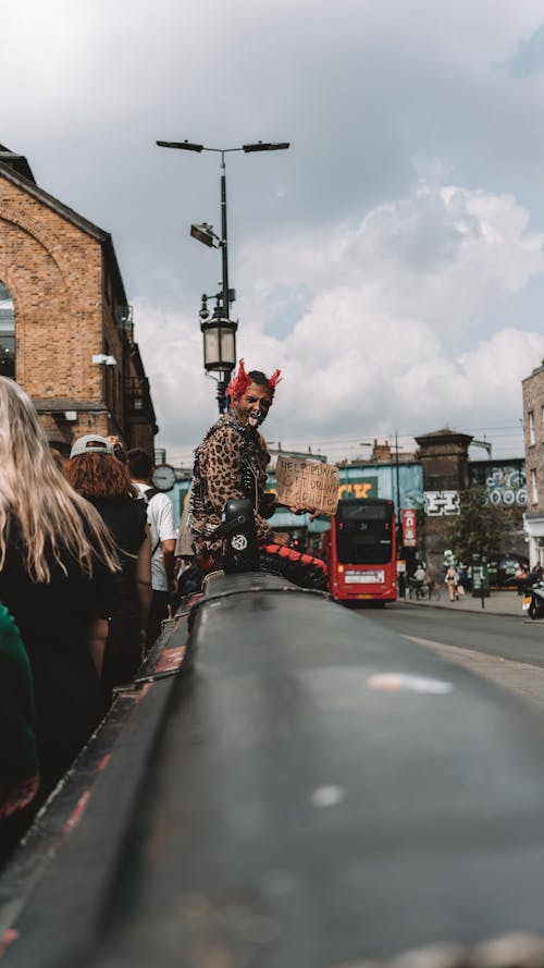 Man in Costume among People on Street in London 