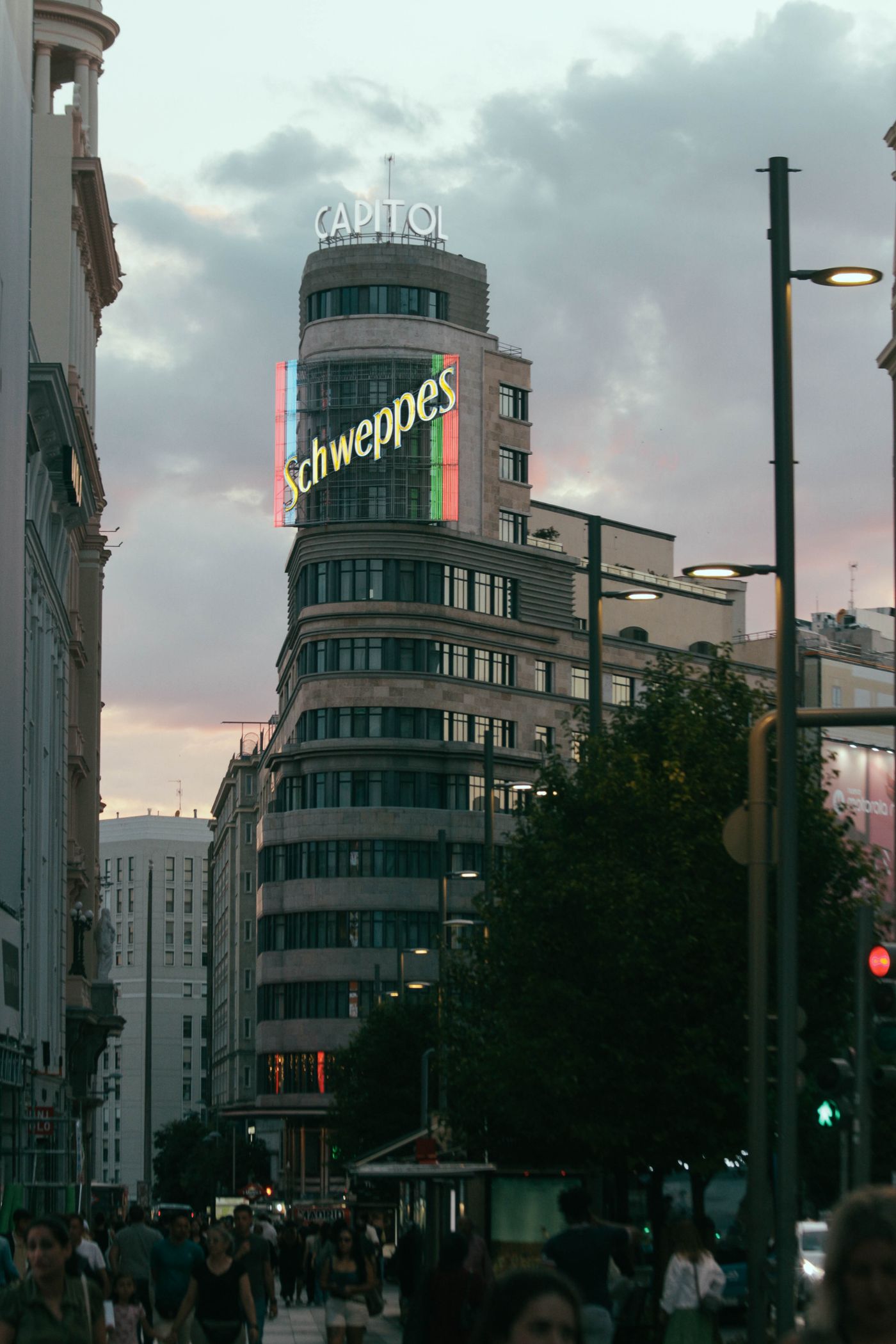 Madrid's Gran Via at sunset with the Art Deco Capitol building and Schweppes sign