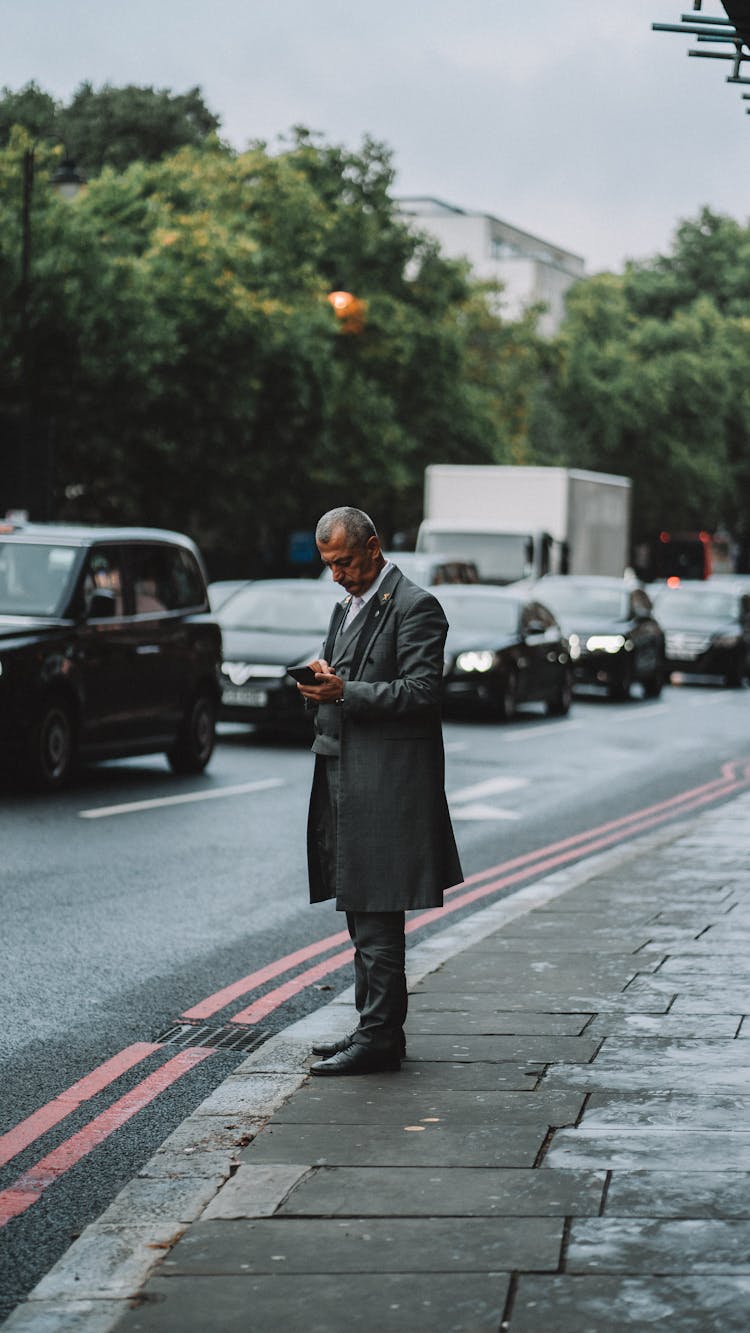 Man In Coat Standing Near Street In London 