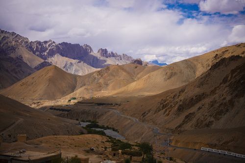 Free Scenic view of the rugged mountains in Ladakh with winding roads and dramatic skies. Stock Photo