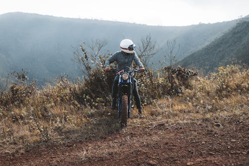 A Person on a Motorcycle in Mountains