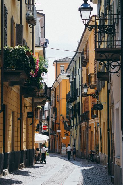 Picturesque narrow cobblestone street lined with colorful buildings in a European city.