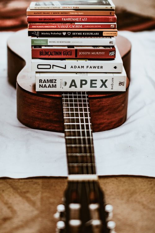 Music Books Stack Stack of Books Lying on a Guitar · Free Stock Photo