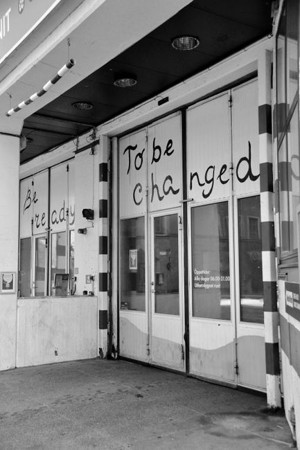Black and white photo of building with motivational text in Stockholm, Sweden.