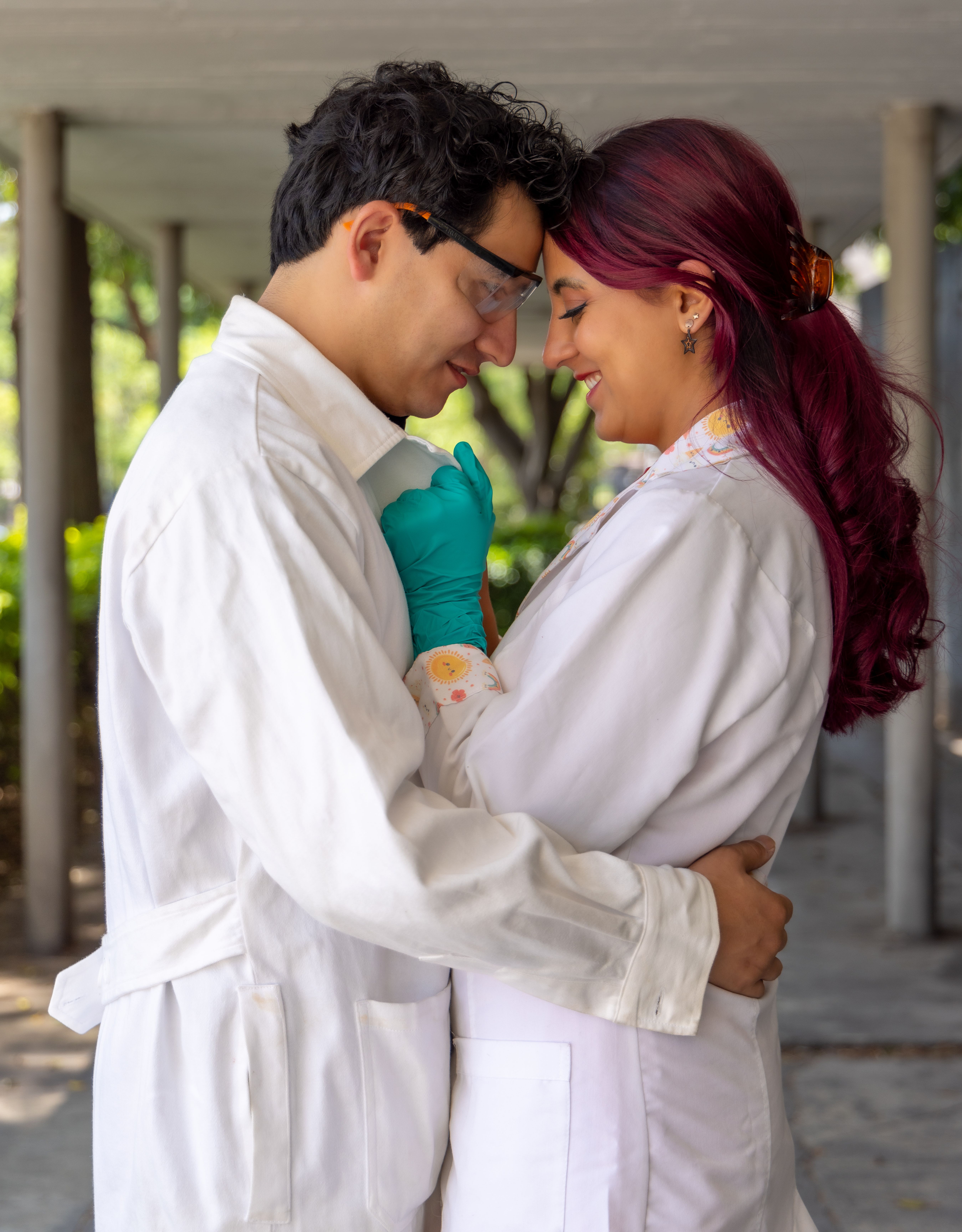 Two chemists embrace in lab coats outdoors, symbolizing love and science unity.