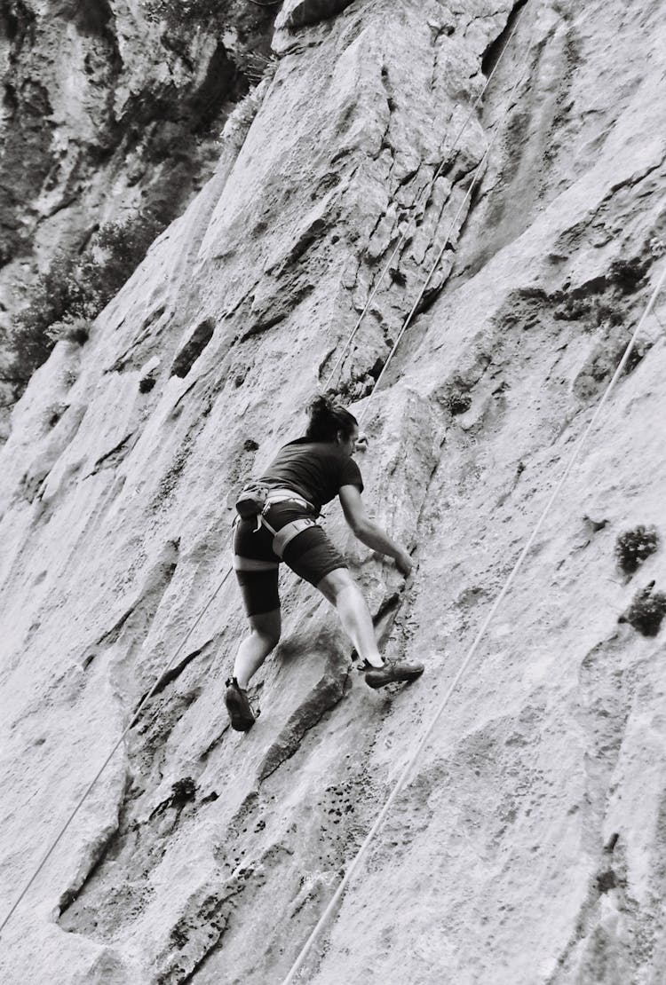 Man Climbing On Stony Wall