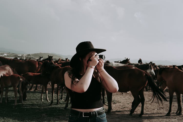 A Woman Taking A Picture With A Camera 