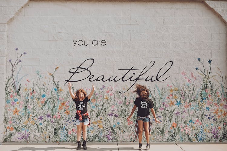 Jumping Girls In Front Of A Street Art