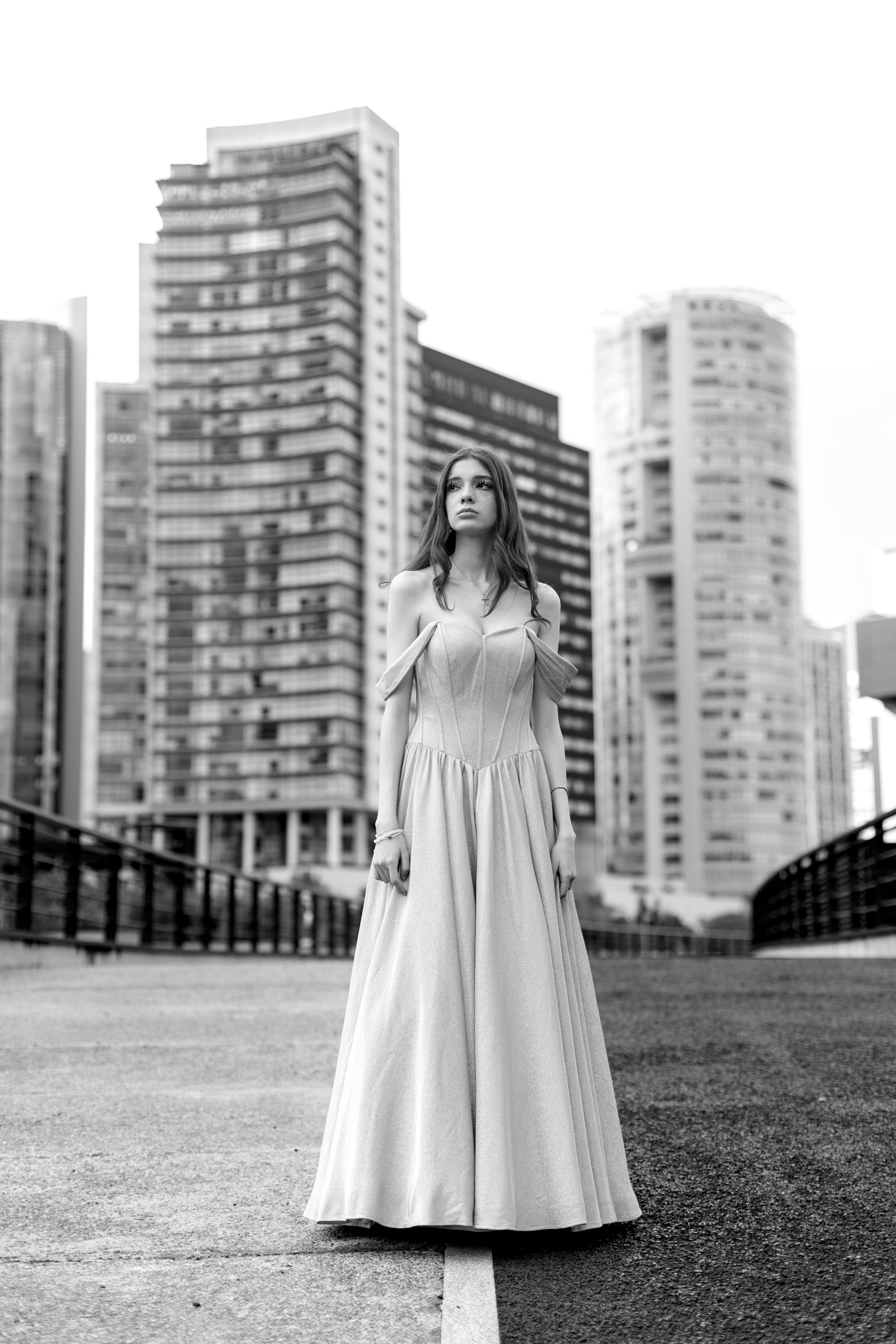 A woman in a long dress standing on a bridge · Free Stock Photo