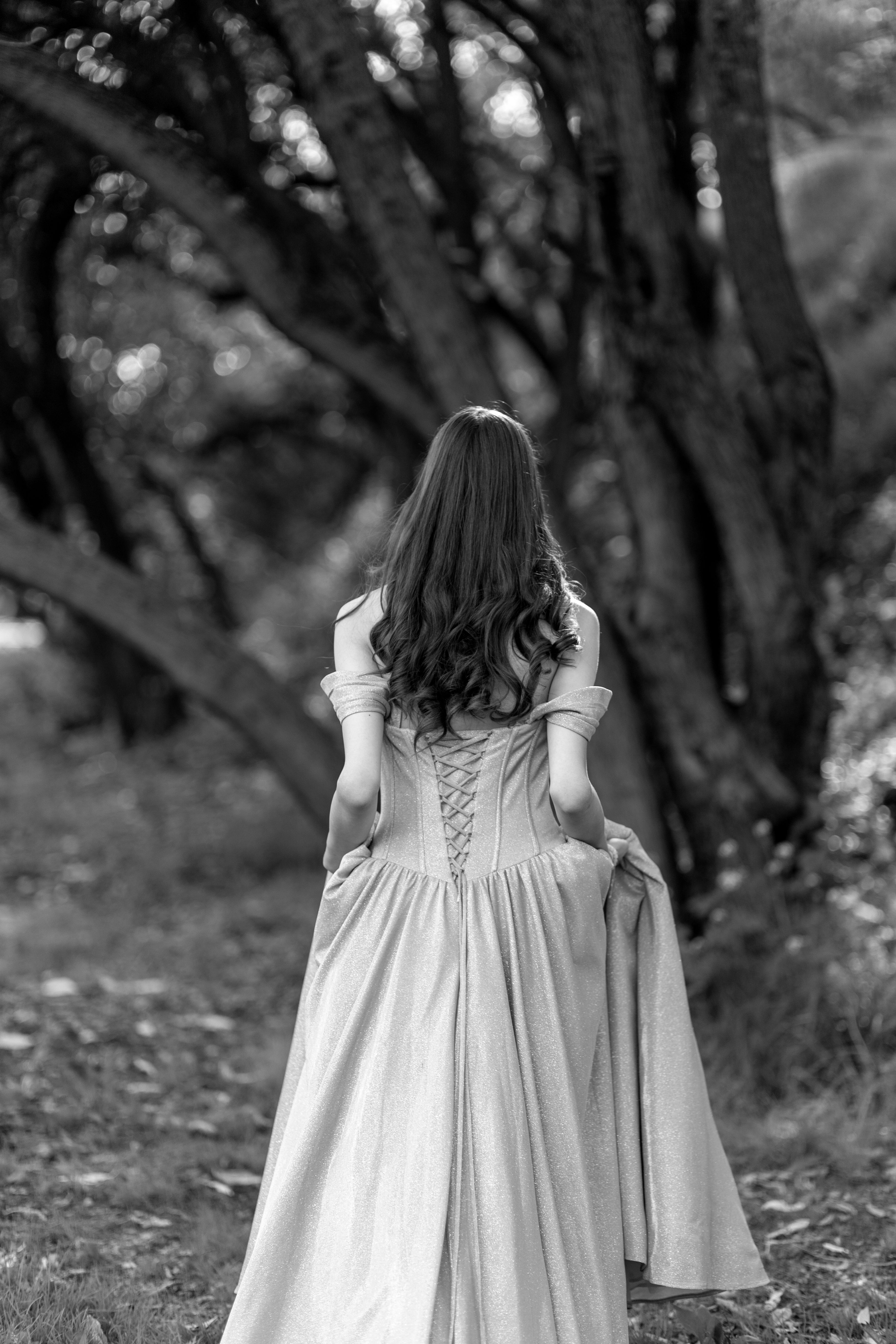 A woman in a long dress walking through the woods · Free Stock Photo
