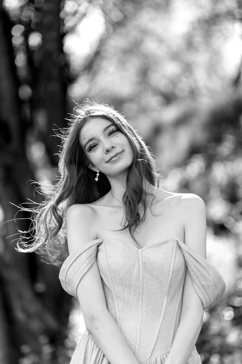 Gorgeous Young Woman in Dress Posing in Park