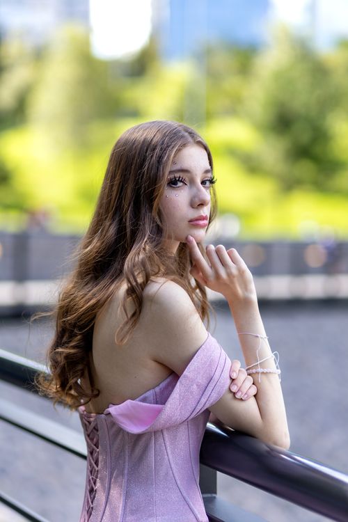 A woman in a pink dress is posing for a photo · Free Stock Photo