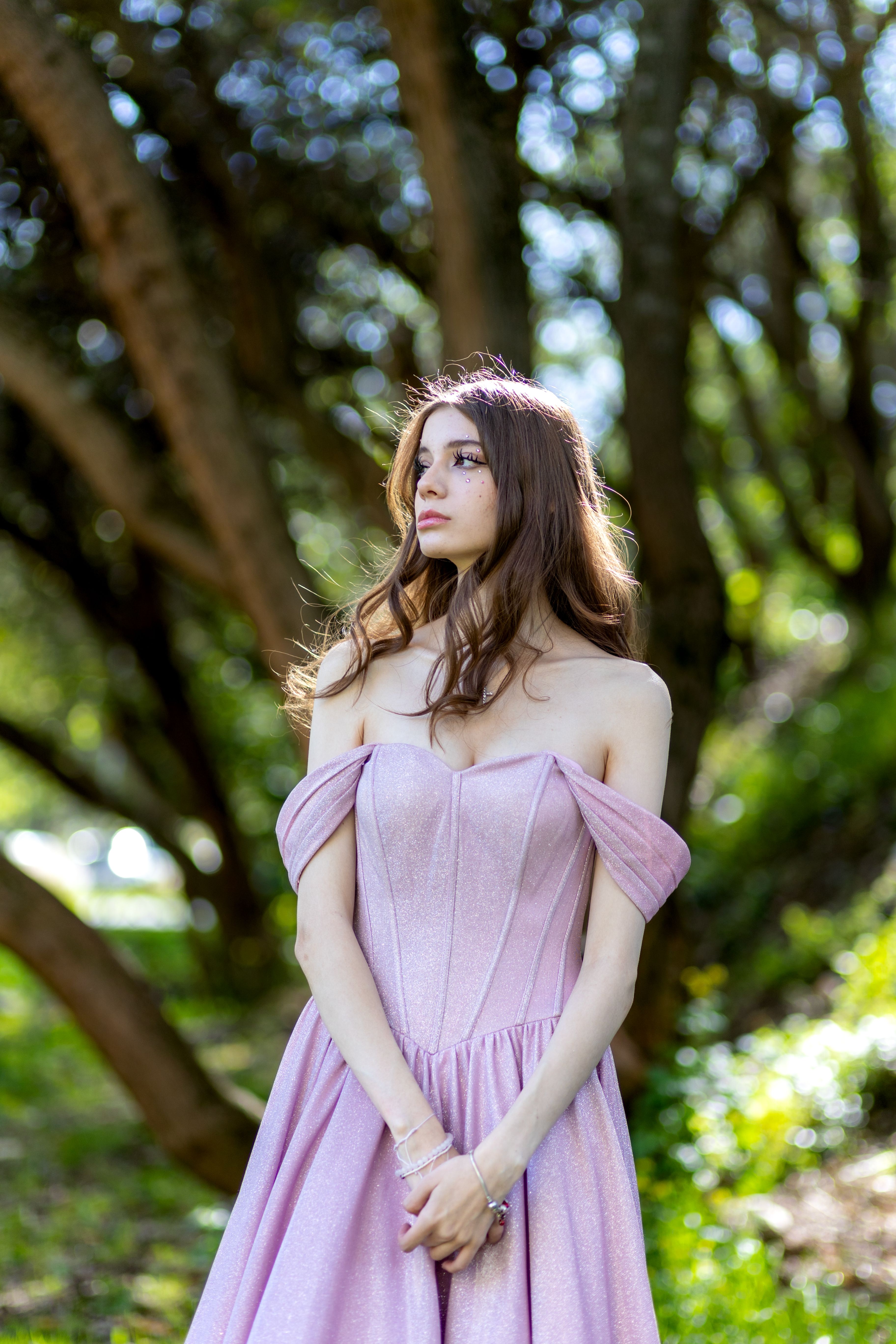 A woman in a pink dress is standing in the woods · Free Stock Photo