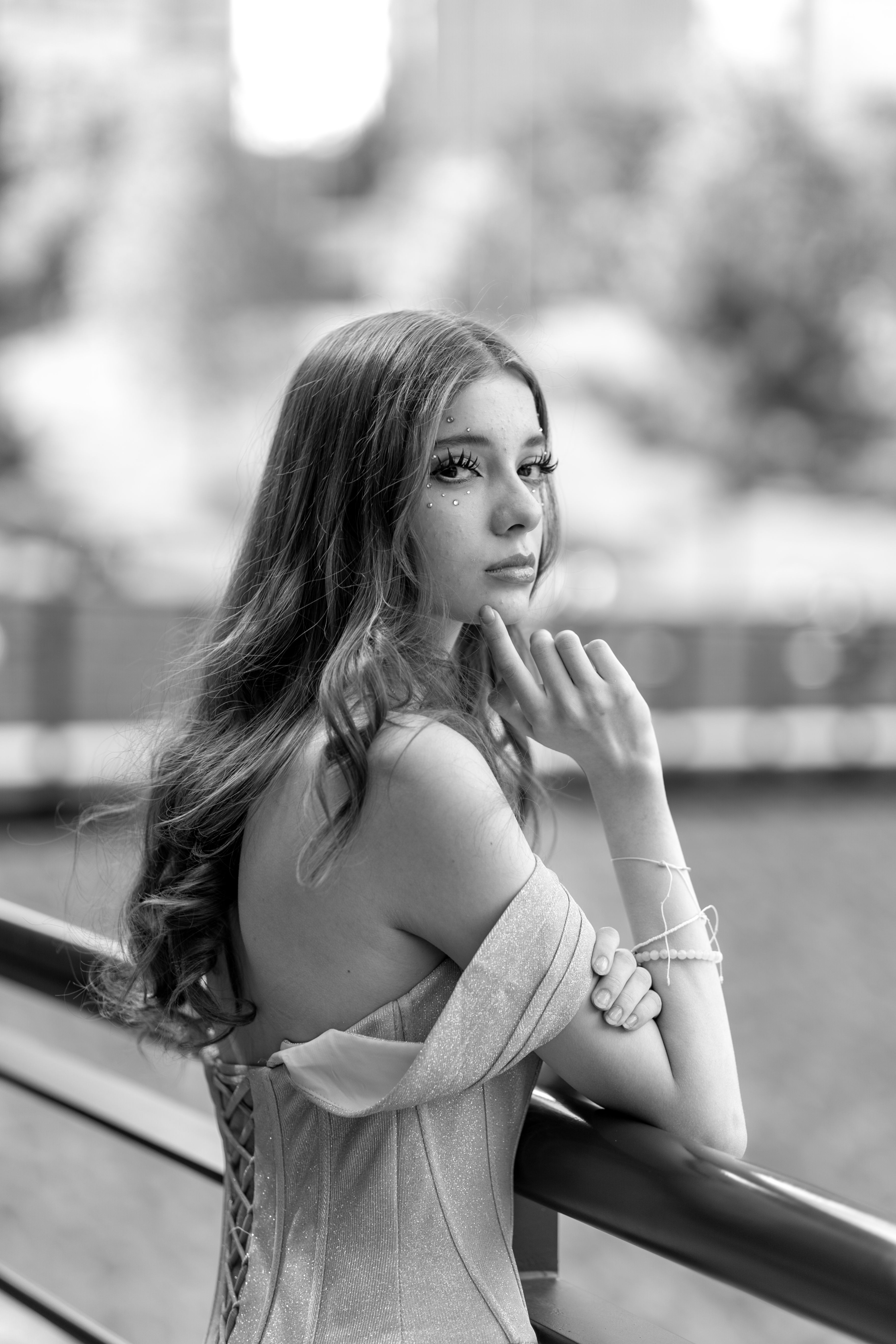 A woman in a dress leaning on a railing · Free Stock Photo