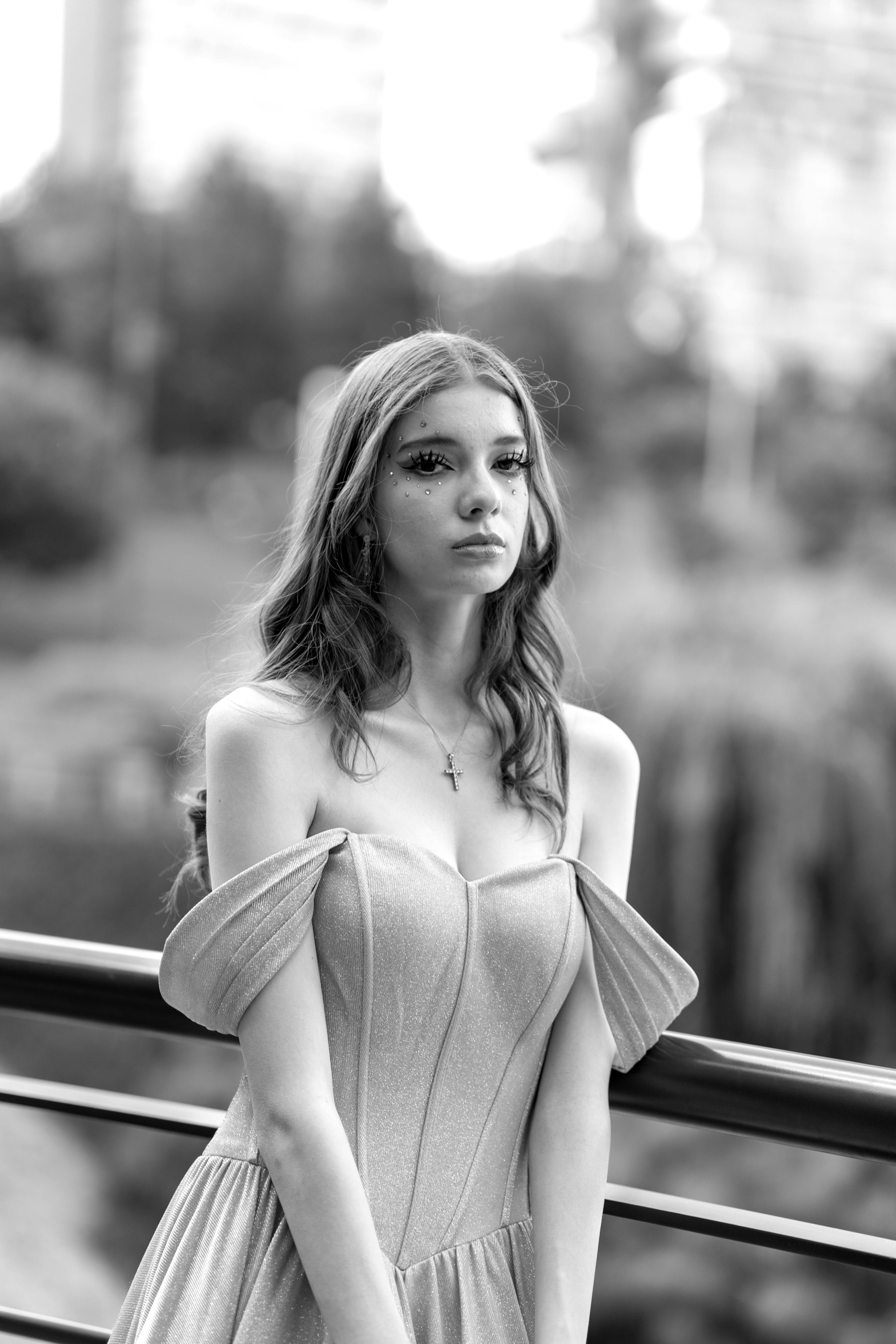 a woman in a long dress posing on a bridge