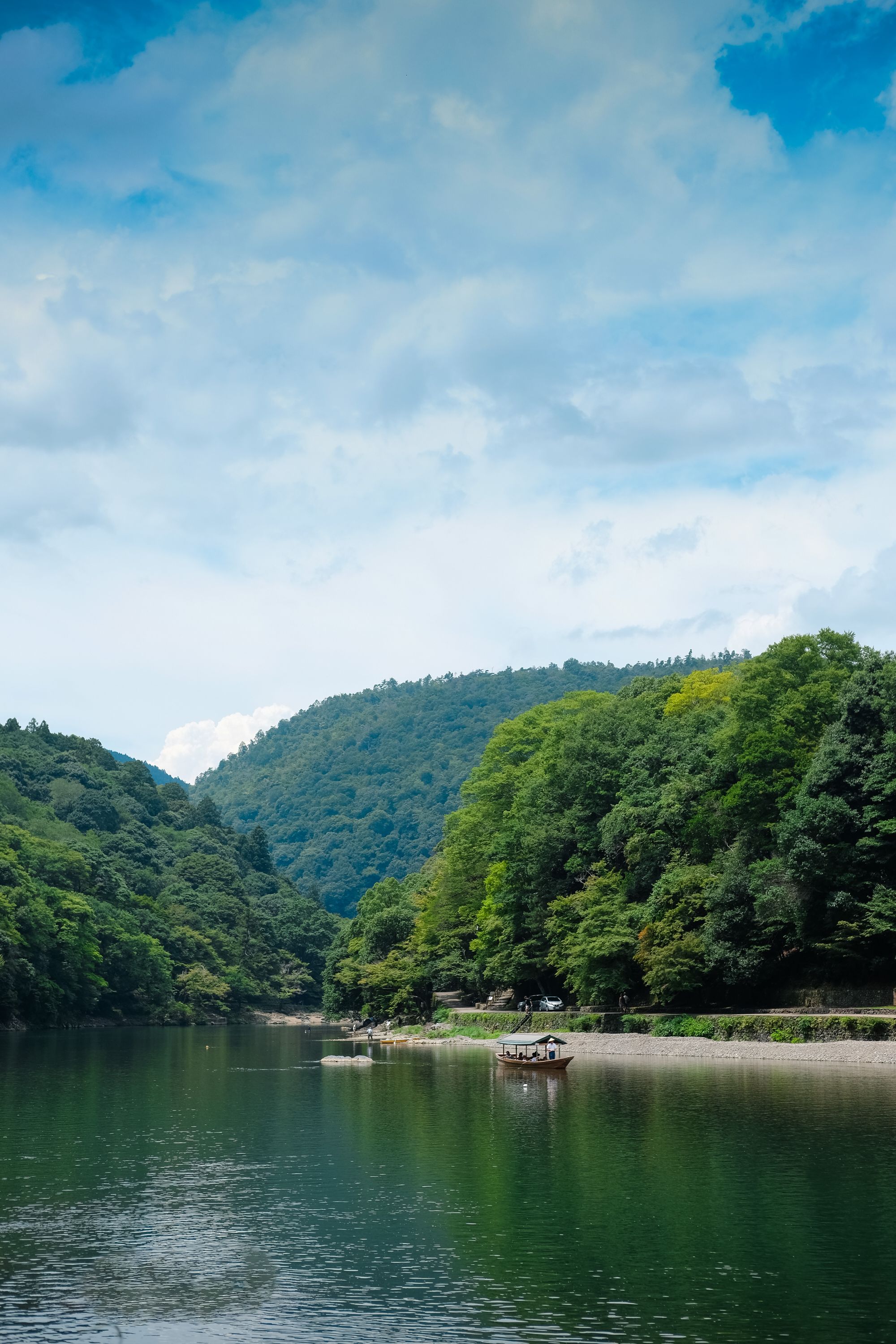 Serene river nestled between lush green hills