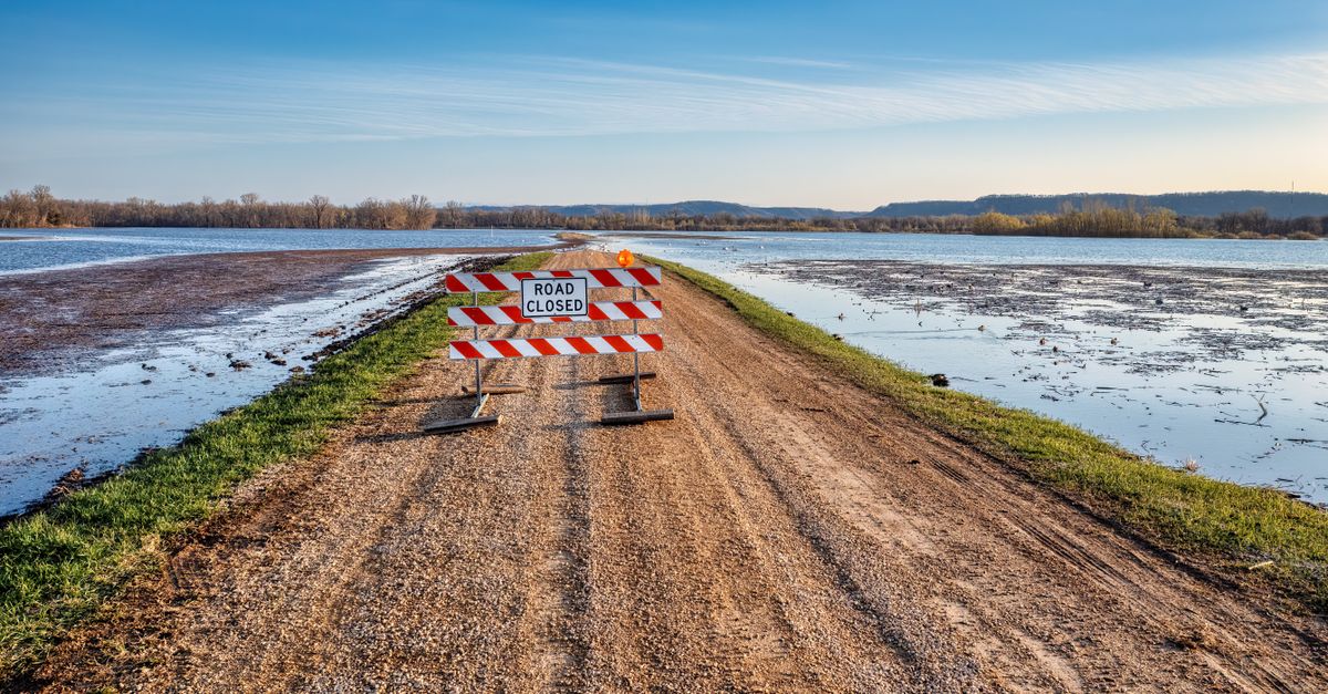 Photo by Tom Fisk A road closed sign on a gravel path next to a flooded area in Kellogg, MN.