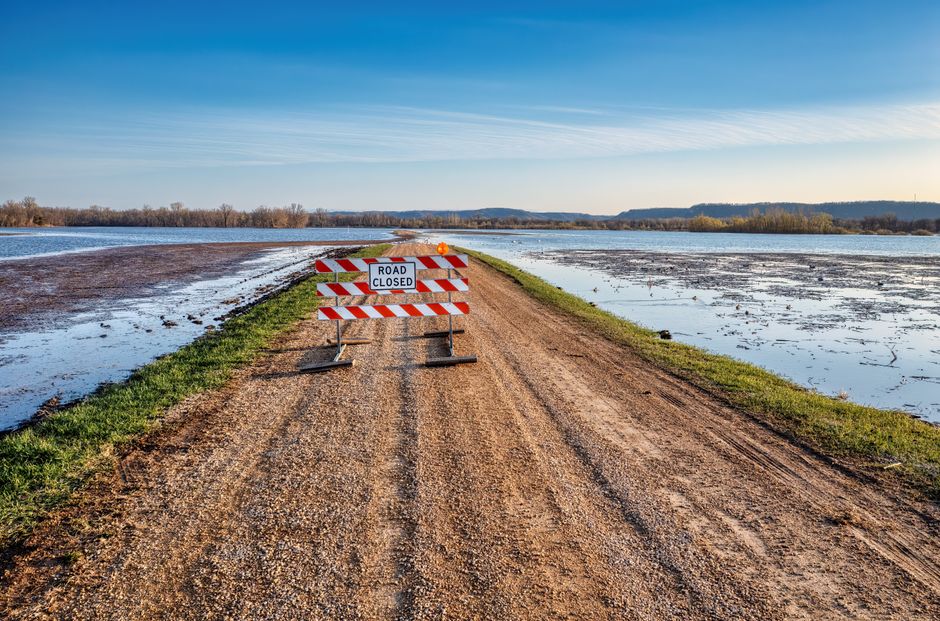Photo by Tom Fisk A road closed sign on a gravel path next to a flooded area in Kellogg, MN.