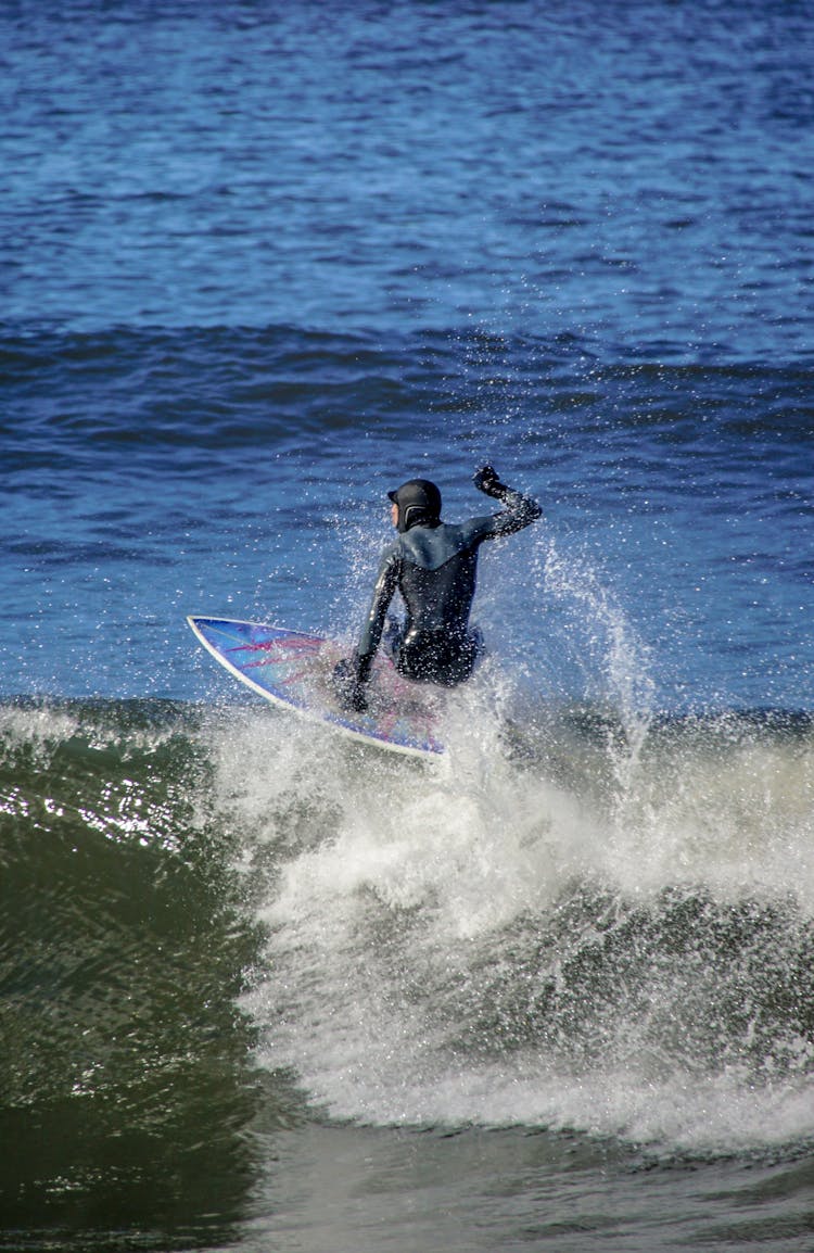 Surfer In Swimsuit On Wave