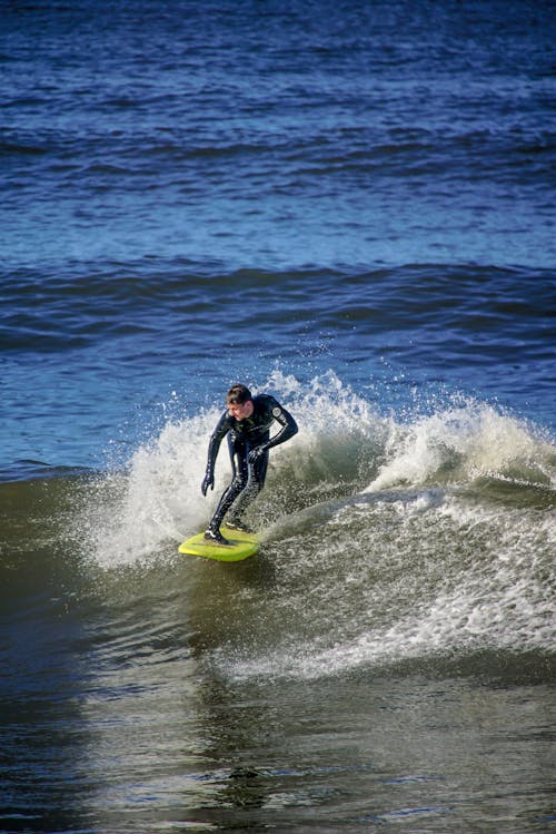 Man Surfing on Wave