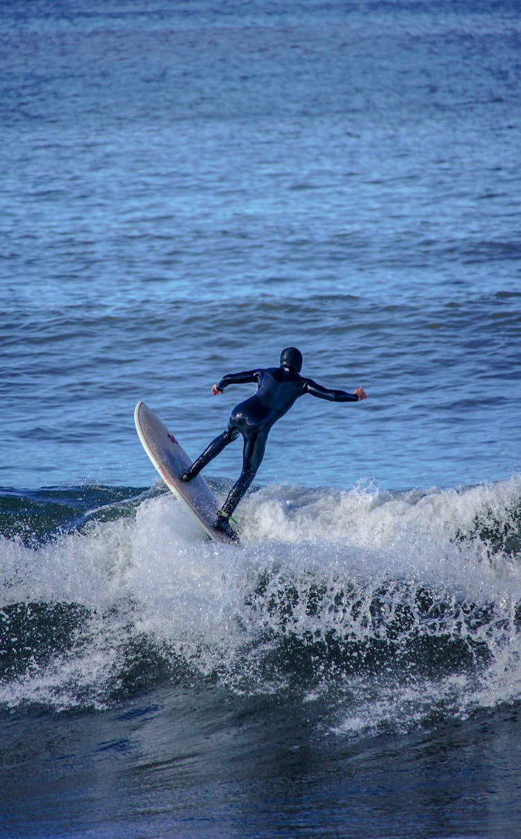 Surfer On Wave On Sea Shore