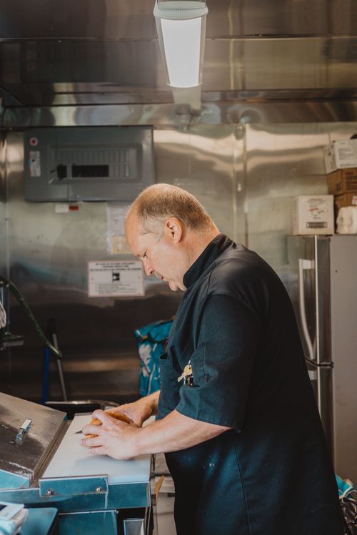 Free A skilled chef focuses on cooking in a stainless steel kitchen environment. Stock Photo