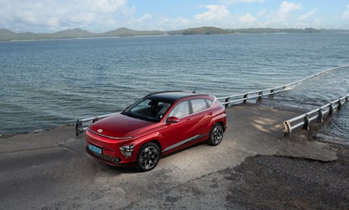 Electric Red Hyundai Kona on Seashore