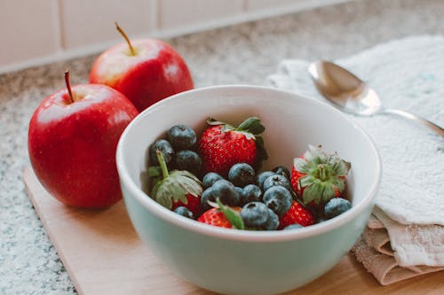 Bowl of Strawberries and Berries on Chopping Board